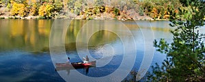 Couple Canoeing on Peaceful Mountain Lake